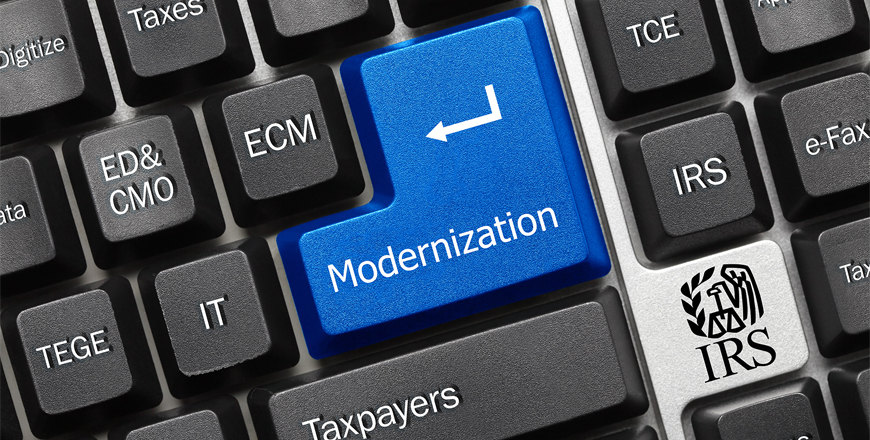 Keyboard with IRS division names on the keys and a blue "Enter" key with Modernization on it